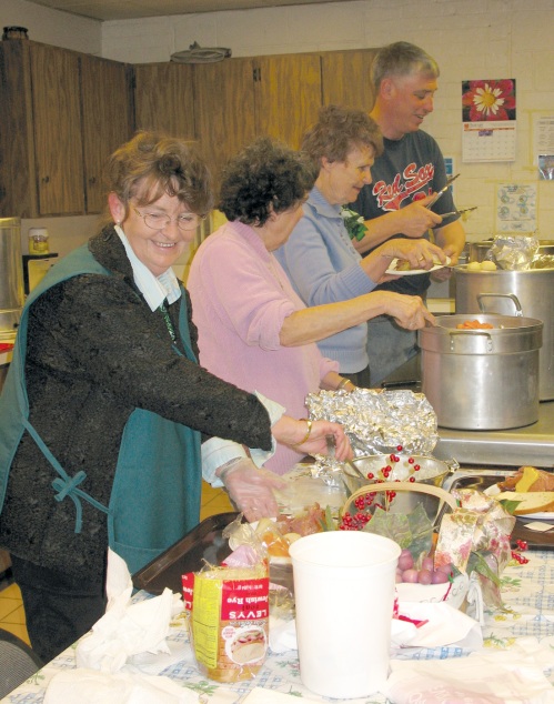 More than 200 people celebrated an early St. Patrick’s Day at the Naugatuck Senior Center’s annual corned beef and cabbage dinner last Thursday. Helping out in the kitchen were, from left: Marge Pierce, Sandra Clark, Carole Mancini and Jim Goggin.